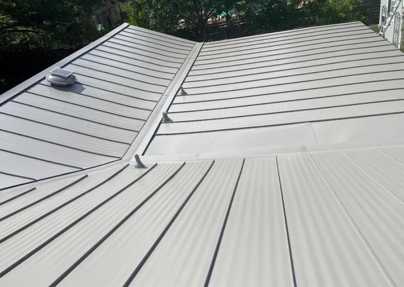 Solar attic fan installed on a metal roof for Roof Ventilation in Webster City